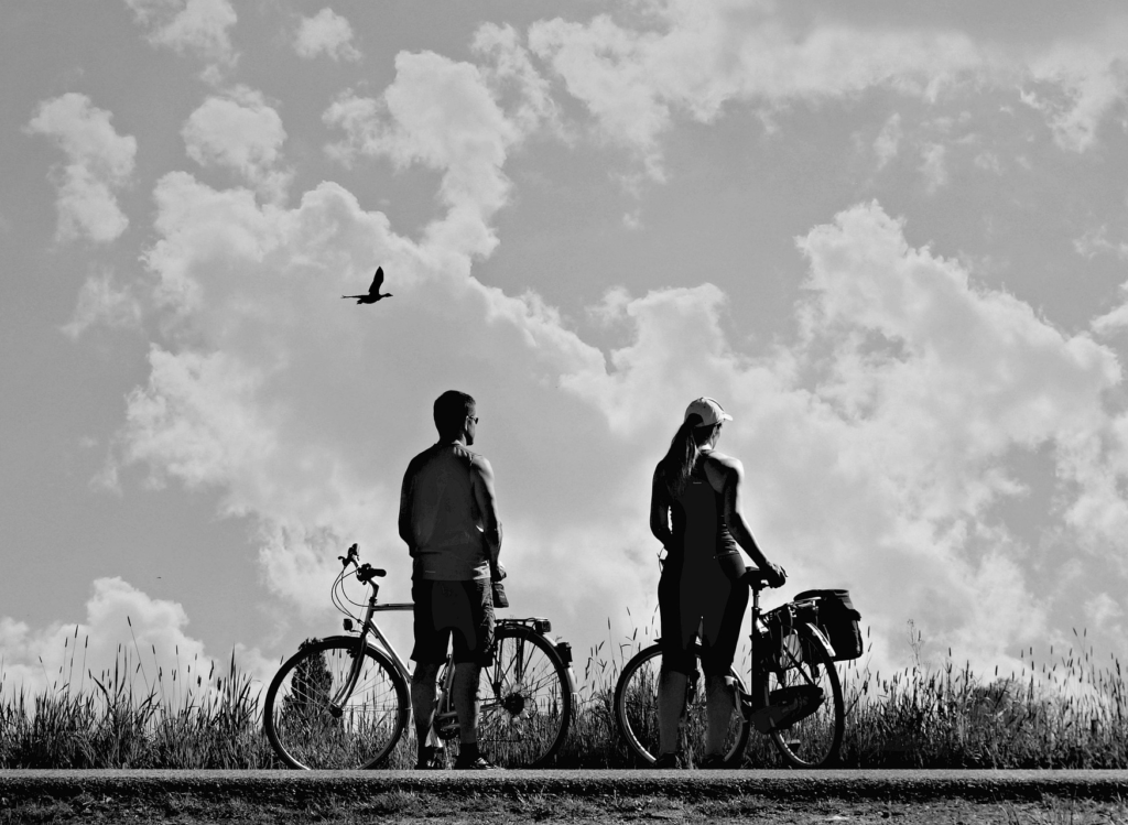 Couple Standing Next to Bikes B&W Photograph