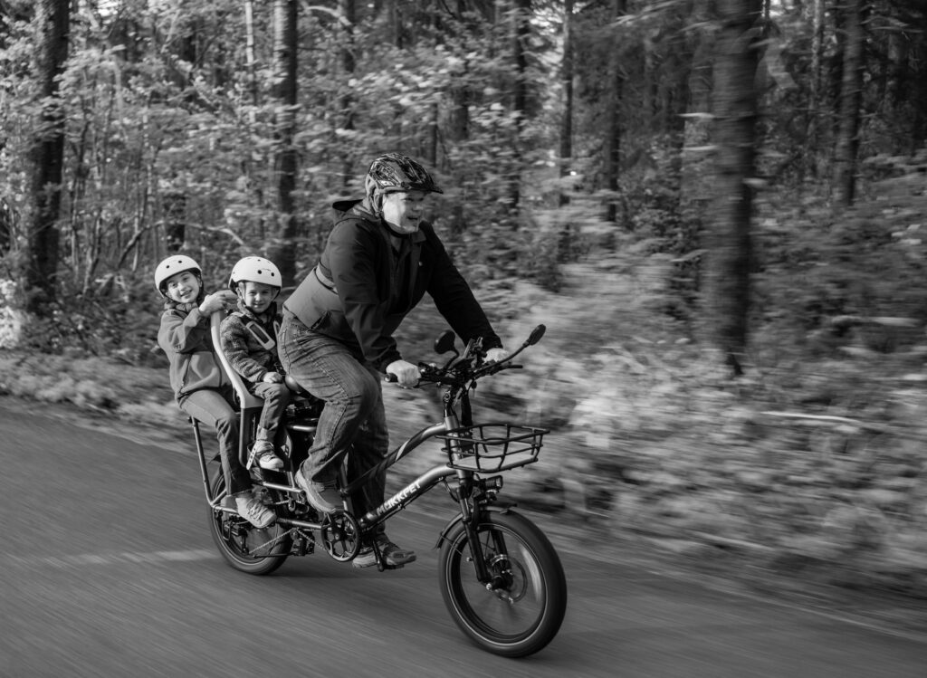 Dad with Two Kids on Back of Bike - B&W Photograph