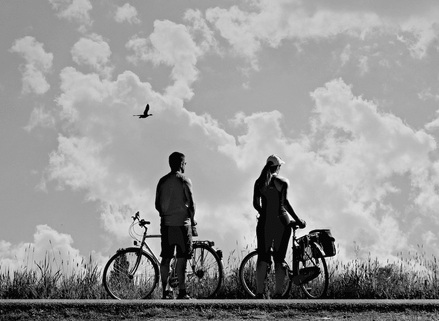 Couple Standing Next to Bikes B&W Photograph